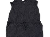 the little girl is wearing a gray romper and a black top