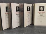 three books with pictures of men and women on them sitting on a table