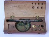 a small wooden box with a clock inside of it