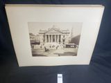 black and white photograph of an old building with people in front of it