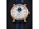 a lange watch with a white dial and blue leather strap