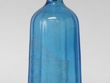blue glass soap dispenser with a brass handle