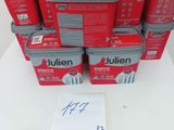 a stack of red boxes with labels on them sitting on a table