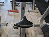 a row of stationary exercise bikes in a gym