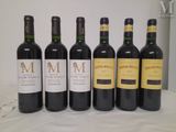 six bottles of wine are lined up on a table