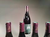 several bottles of wine are lined up on a table