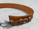 a brown leather dog collar with a metal hook