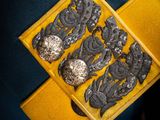 an image of a gold and black broochle on a blue jacket