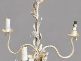 a white chandelier with three candles on it