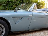 a blue sports car parked on the side of the road