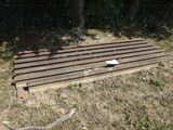 a wooden bench sitting in the middle of a field