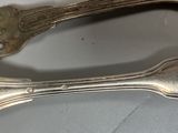 two forks and two spoons on a table