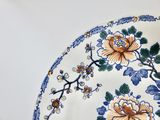 a plate with flowers on it sitting on a table