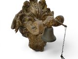 a metal bell with a chain hanging from it ' s side