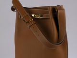 brown leather bucket bag on white background