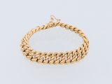 a gold chain bracelet with a clasp on a white background