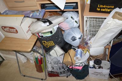 a pile of clutter on the floor in a cluttered room