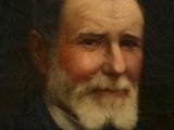 portrait of a man with a white beard and a black jacket