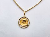 a necklace with a gold coin on a gold chain
