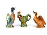 three figurines of birds that are sitting next to each other