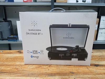 an open box of a record player sitting on top of a wooden table