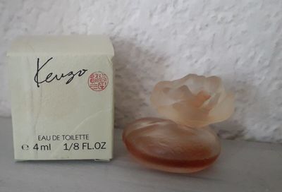 an image of a bottle of perfume sitting next to a box of soap