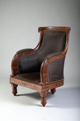 a brown chair with a black seat on a white background