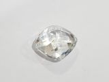 a close up view of a faceted diamond on a white surface