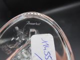 someone is holding a glass object with a tag on it