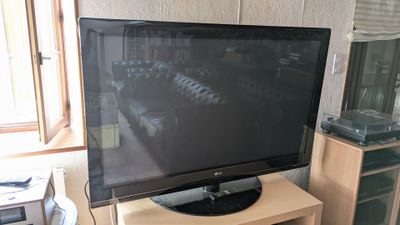 un téléviseur à écran plat posé sur un support dans un salon
