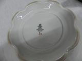 a white plate with a green and red emblem on it