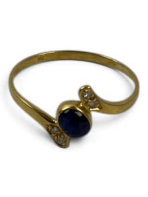 a close up of a gold ring with a blue stone on it