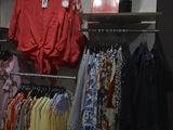 a lot of shirts hanging on a rack in a store