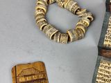 a bracelet, a bracelet, and a book on a table