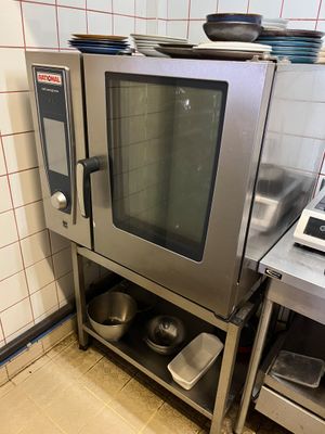 a silver oven sitting in a kitchen next to a stove