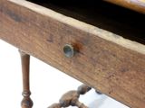 a wooden table with a drawer on top of it