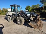 a tractor that is parked in a parking lot