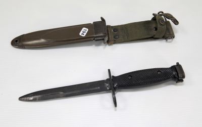 two different types of knives on a white surface