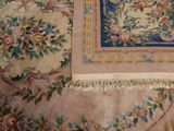 an image of a rug with flowers and birds on it