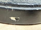a close up of a black pan with a hole in it