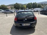 a black car parked in a parking lot next to other cars