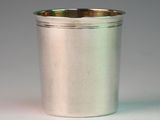 a silver cup that is sitting on a table