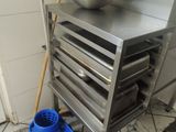 a blue bucket sitting on the floor next to a metal cabinet