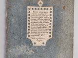 an old book with writing on it sitting on a table