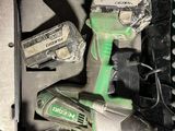 une perceuse sans fil verte et deux autres outils dans une boîte