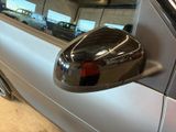 reflection of a car in the side mirror of a car in a garage