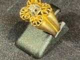 a gold ring with a lion head on top of it