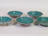 six blue and white bowls with designs on them on a white surface