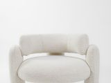a white chair sitting on top of a white floor next to a white wall