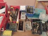 many different types of tools in boxes on the table